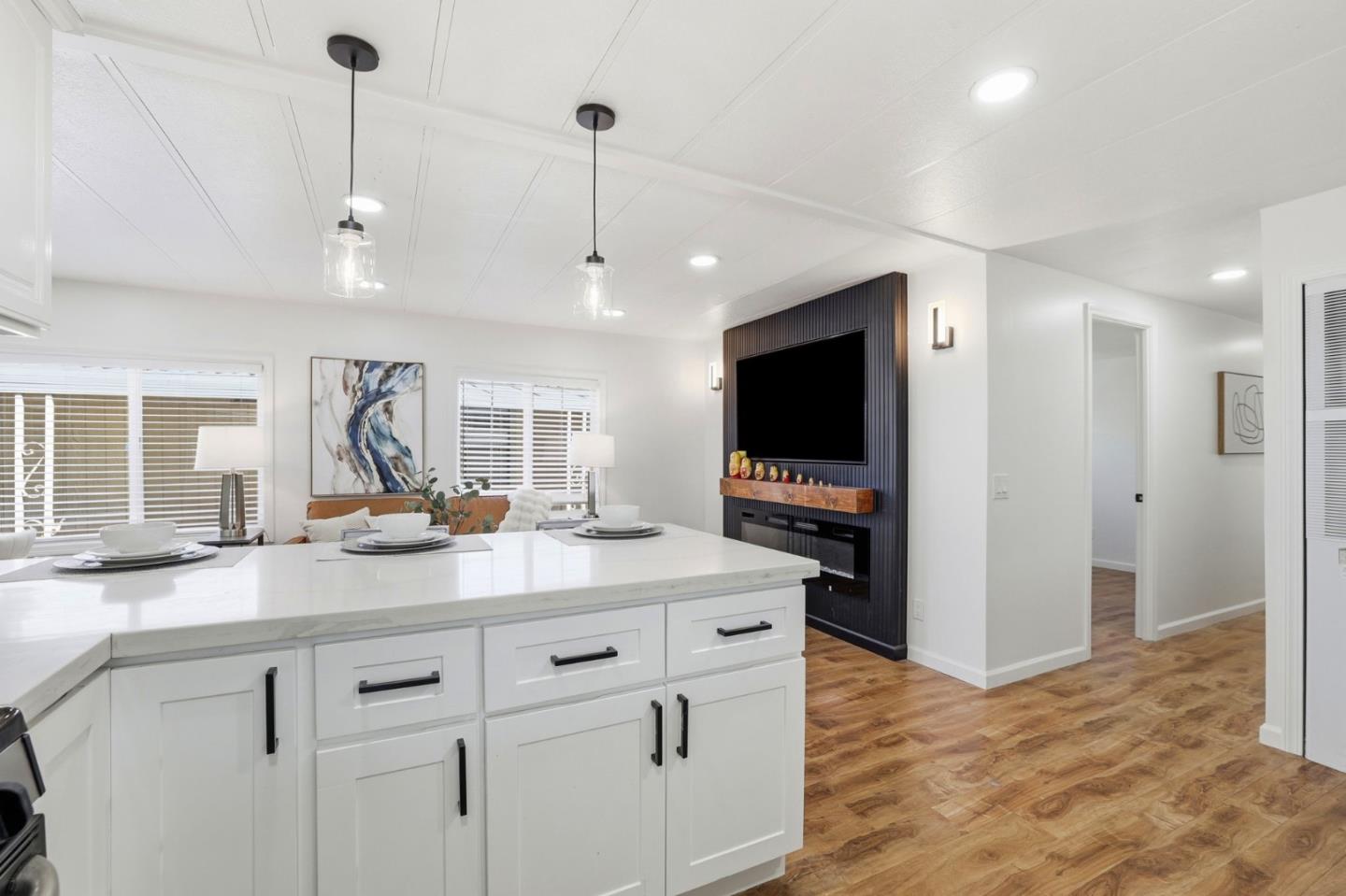 555 Umbarger Road, Unit 31 San Jose, CA 95111 - Photo 7 of 18 a kitchen with stainless steel appliances granite countertop a sink a stove and a wooden floor