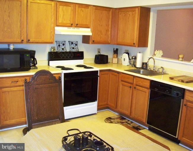 4012 Cutty Sark Road Middle River, MD 21220 - Photo 8 of 16 a kitchen with a sink cabinets and appliances
