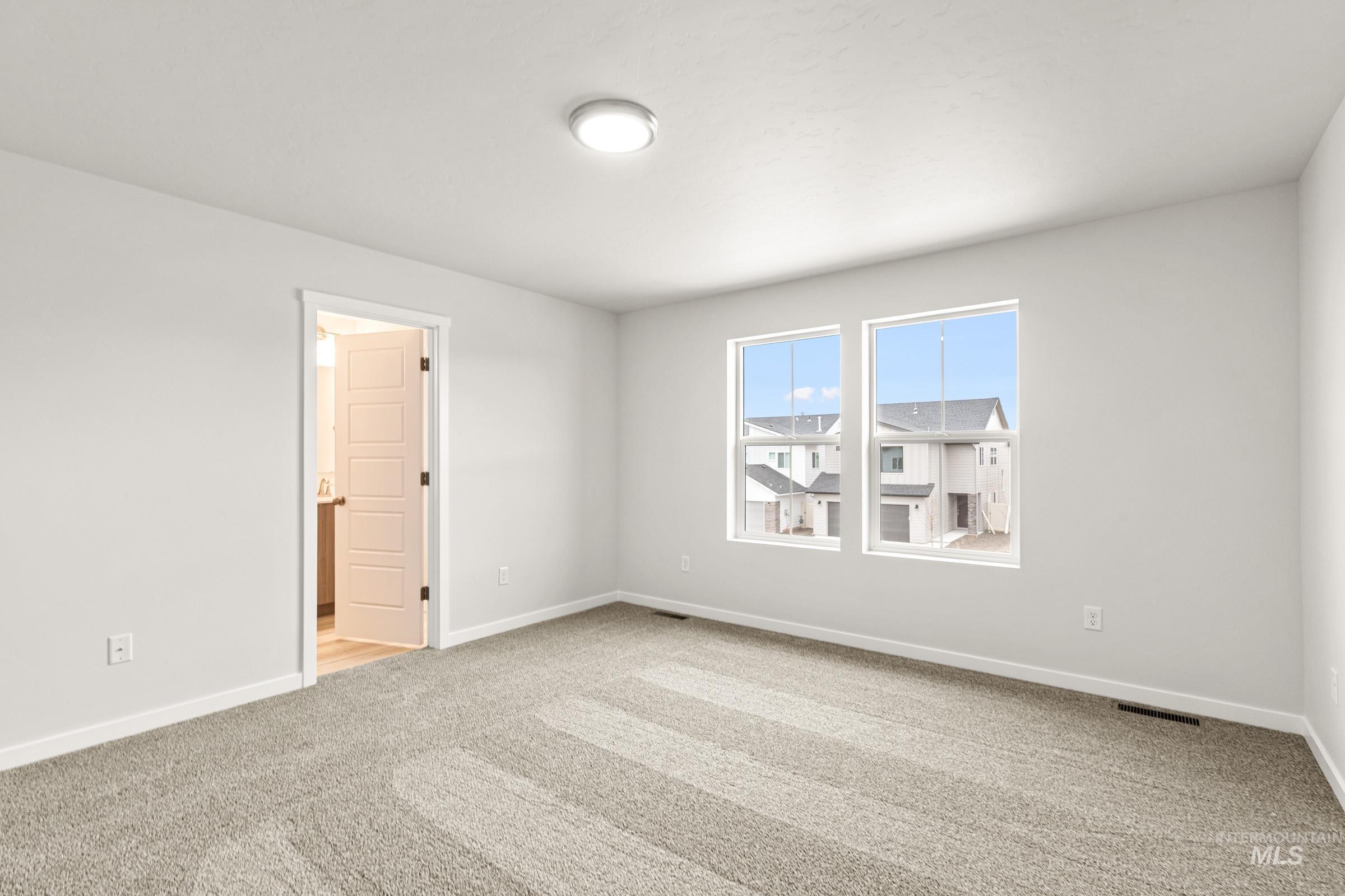 10818 Rutland Street Caldwell, ID 83605 - Photo 17 of 22 Spare room with light colored carpet and baseboards