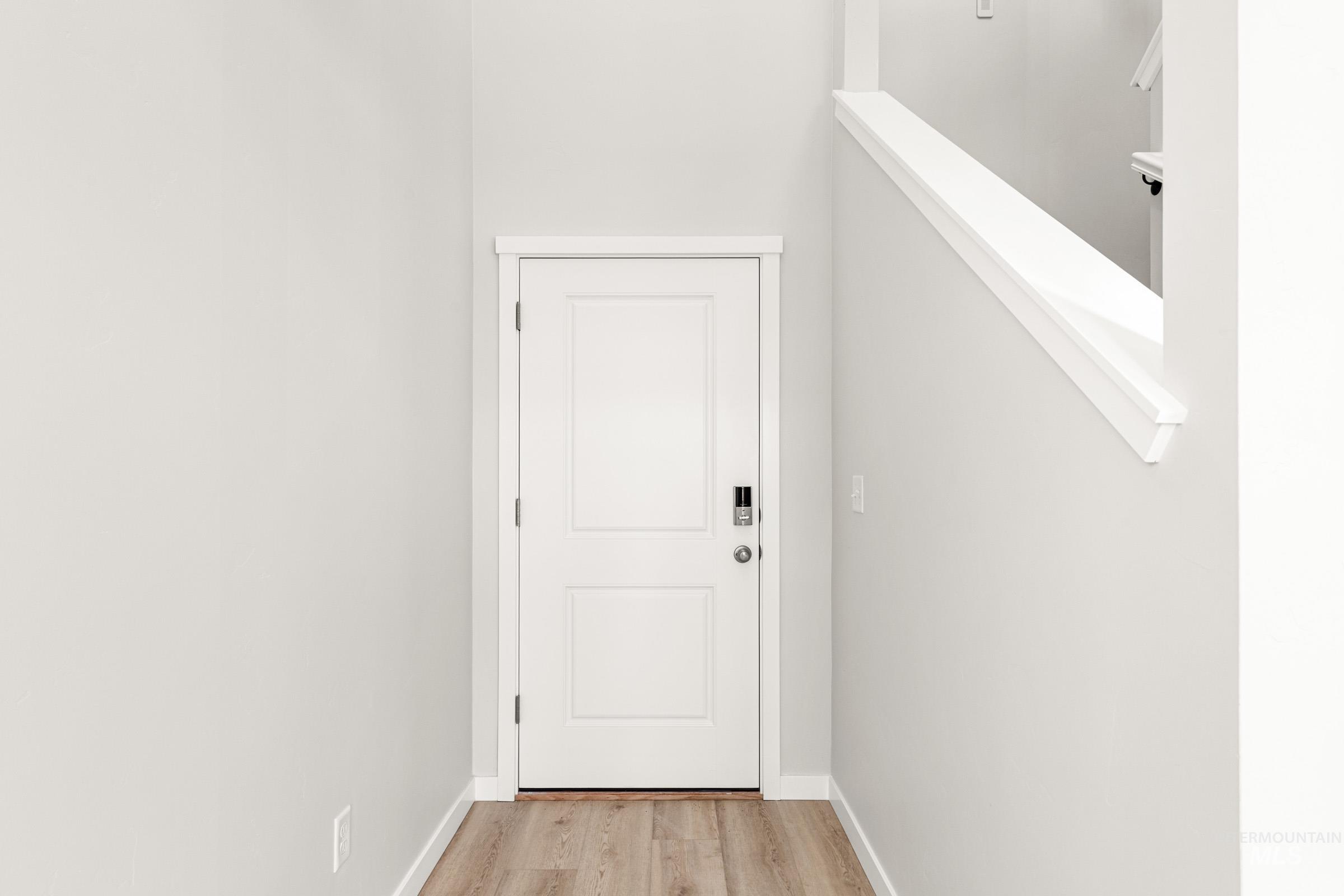 10818 Rutland Street Caldwell, ID 83605 - Photo 2 of 22 Doorway to outside featuring wood finished floors and baseboards