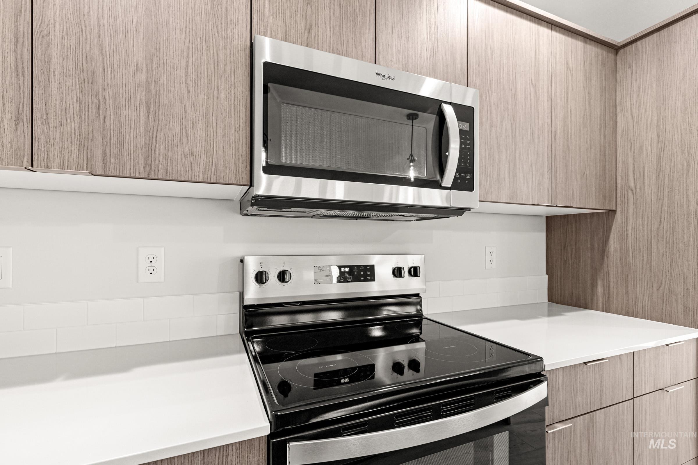 10818 Rutland Street Caldwell, ID 83605 - Photo 4 of 22 Kitchen with stainless steel appliances, modern cabinets, and light wood finish cabinetry