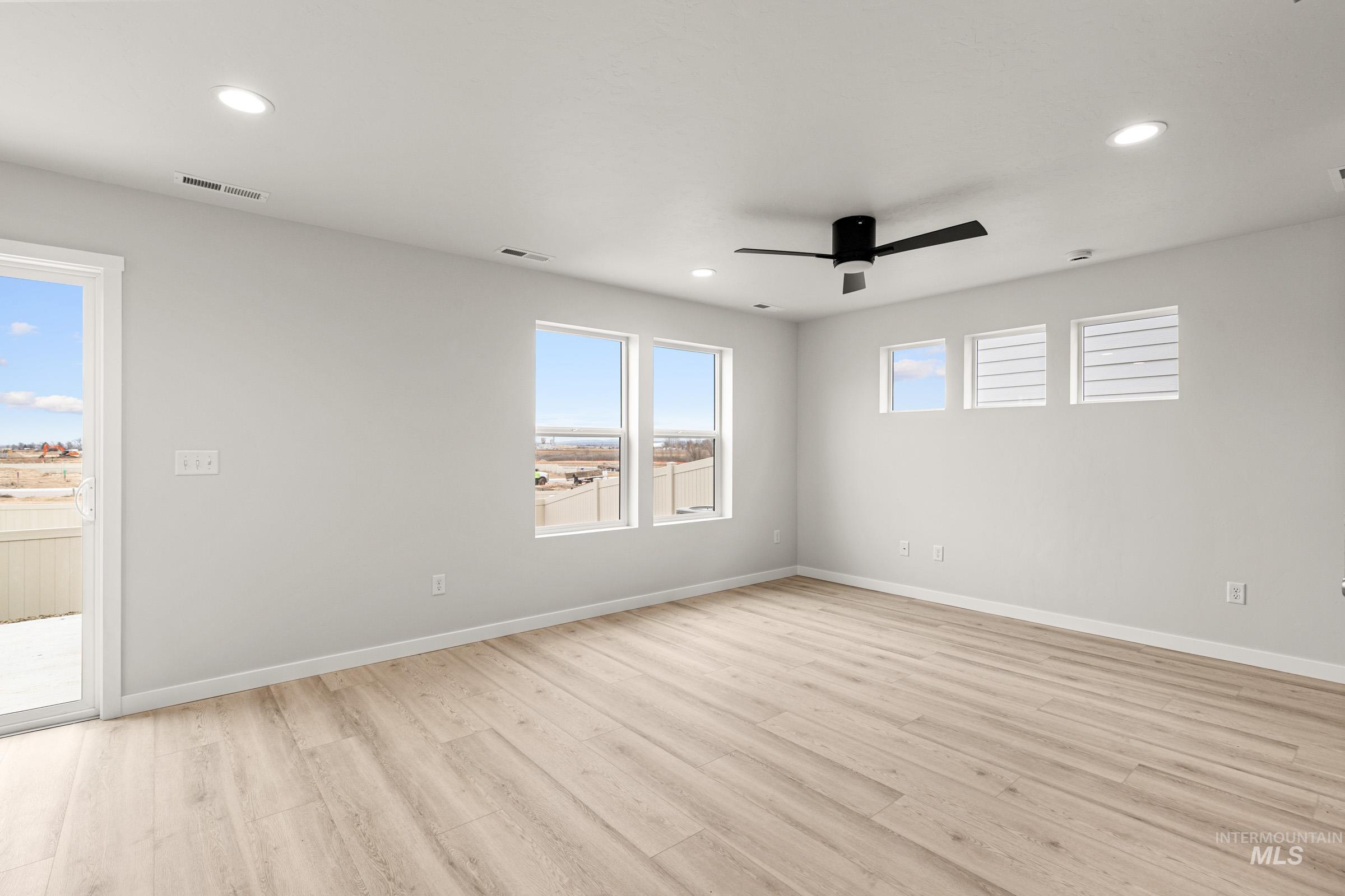 10818 Rutland Street Caldwell, ID 83605 - Photo 8 of 22 Empty room with light wood-type flooring, a ceiling fan, and recessed lighting