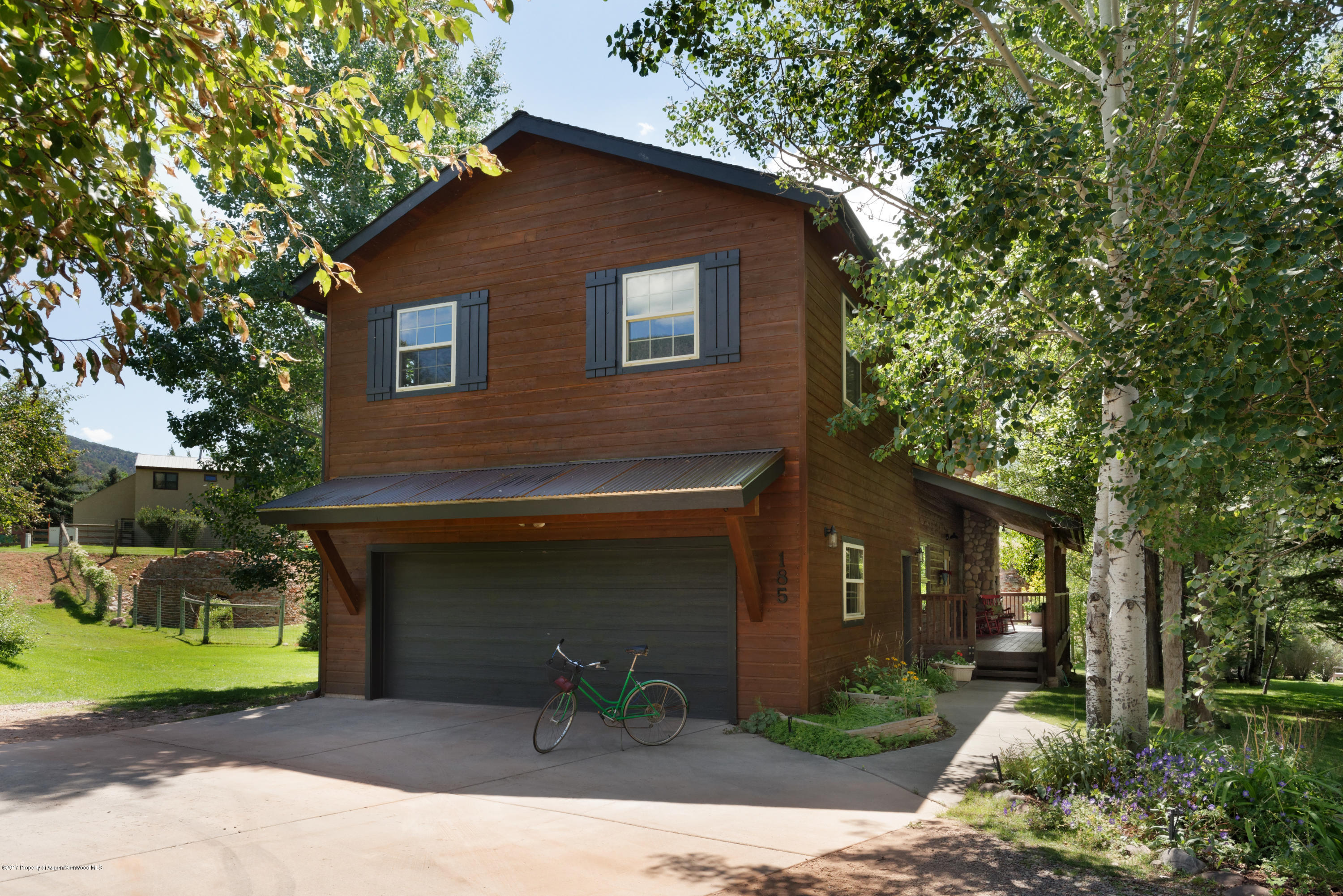 185 Riverside Drive Basalt, CO 81621 - Photo 29 of 34 a front view of a house with a yard and garage