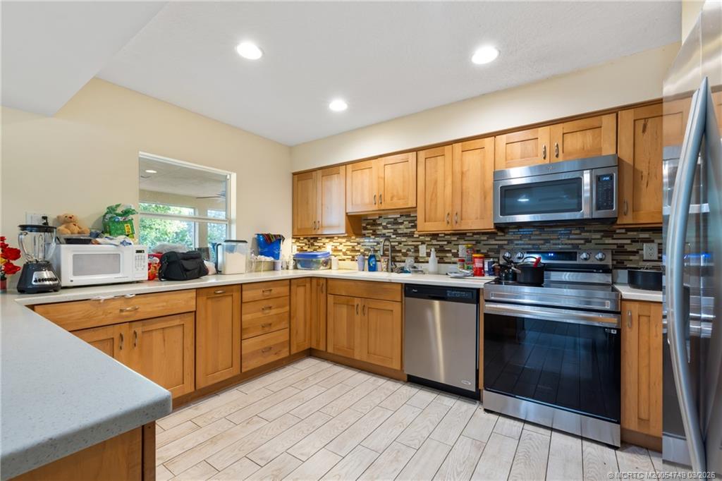 15848 129th Terrace North Jupiter, FL 33478 - Photo 20 of 52 a kitchen with stainless steel appliances a stove sink and microwave
