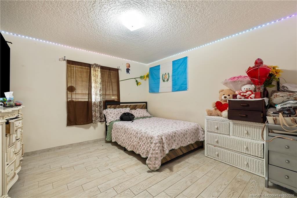 15848 129th Terrace North Jupiter, FL 33478 - Photo 22 of 52 a bedroom with a bed and cabinets