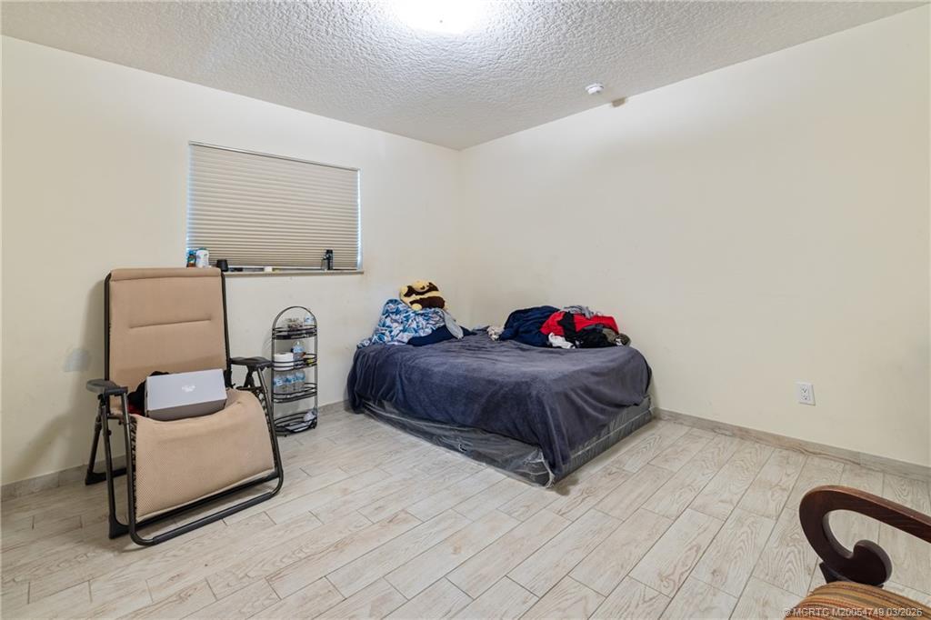 15848 129th Terrace North Jupiter, FL 33478 - Photo 23 of 52 a spacious bedroom with a bed and a couch