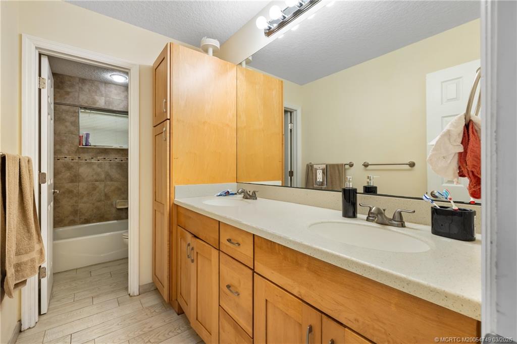15848 129th Terrace North Jupiter, FL 33478 - Photo 24 of 52 a bathroom with a double vanity sink and a mirror