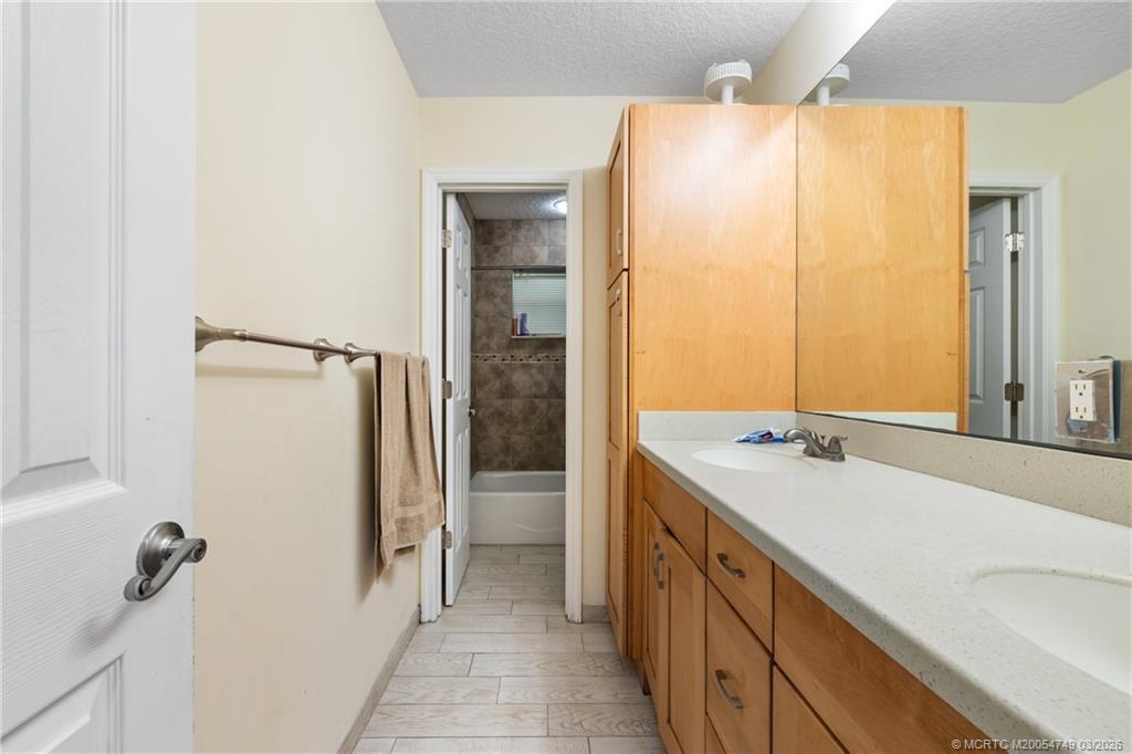 15848 129th Terrace North Jupiter, FL 33478 - Photo 25 of 52 a bathroom with a double vanity sink and mirror