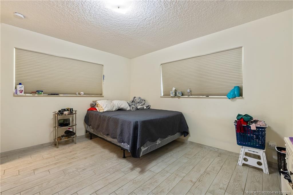 15848 129th Terrace North Jupiter, FL 33478 - Photo 27 of 52 a bedroom with a bed and a dresser in it