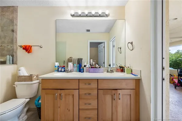 a bathroom with a sink a toilet and a mirror