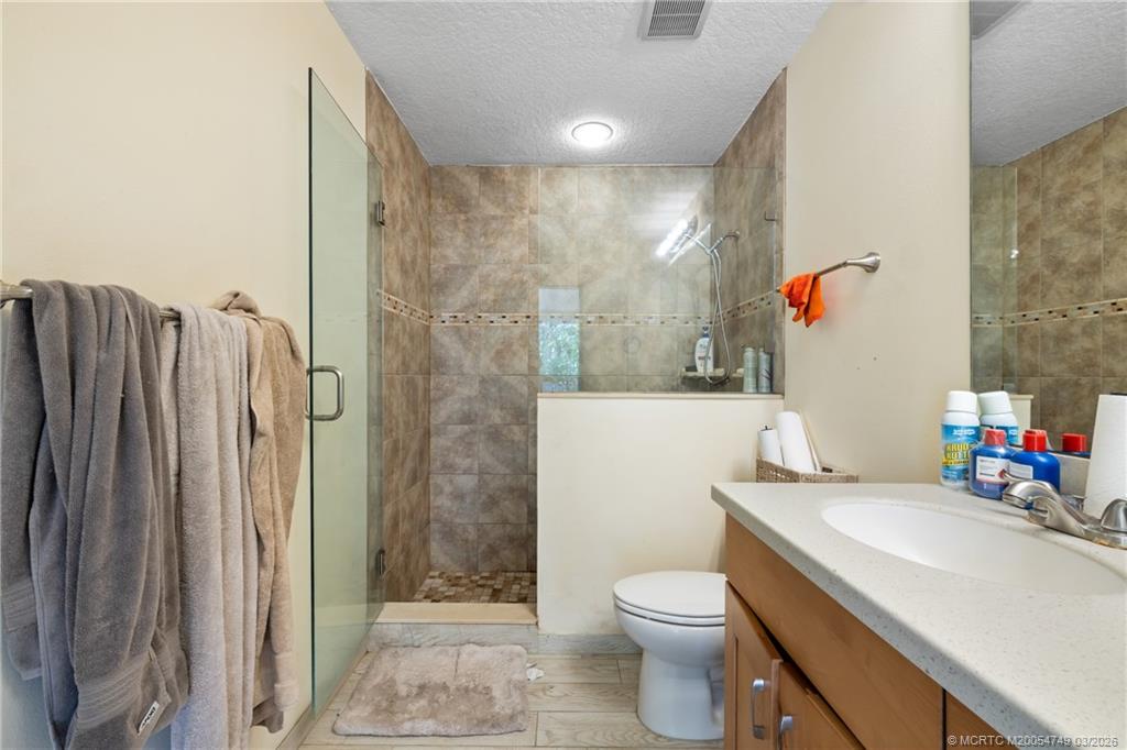 15848 129th Terrace North Jupiter, FL 33478 - Photo 30 of 52 a bathroom with a sink a toilet and shower