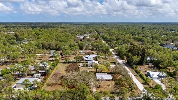 an aerial view of residential building with green space