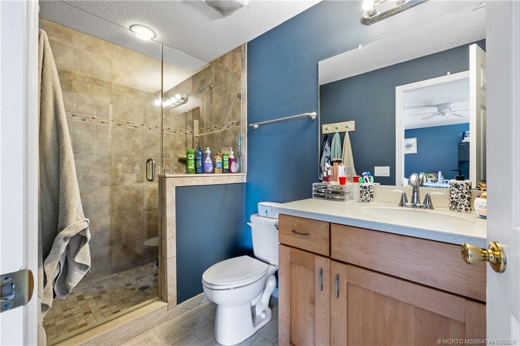 15848 129th Terrace North Jupiter, FL 33478 - Photo 38 of 52 a bathroom with a sink vanity mirror and toilet