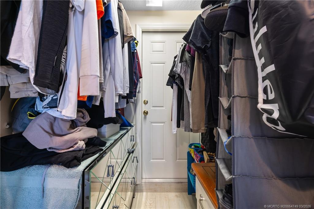 15848 129th Terrace North Jupiter, FL 33478 - Photo 39 of 52 a view of walk in closet with clothes and shoes