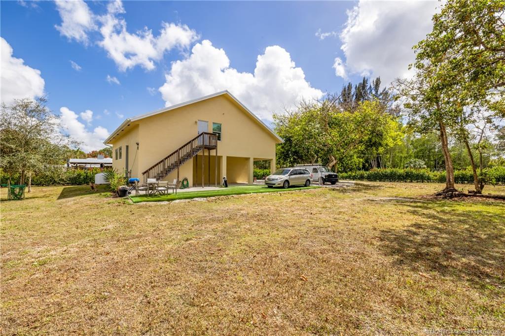 15848 129th Terrace North Jupiter, FL 33478 - Photo 6 of 52 a view of a house with a yard and garage