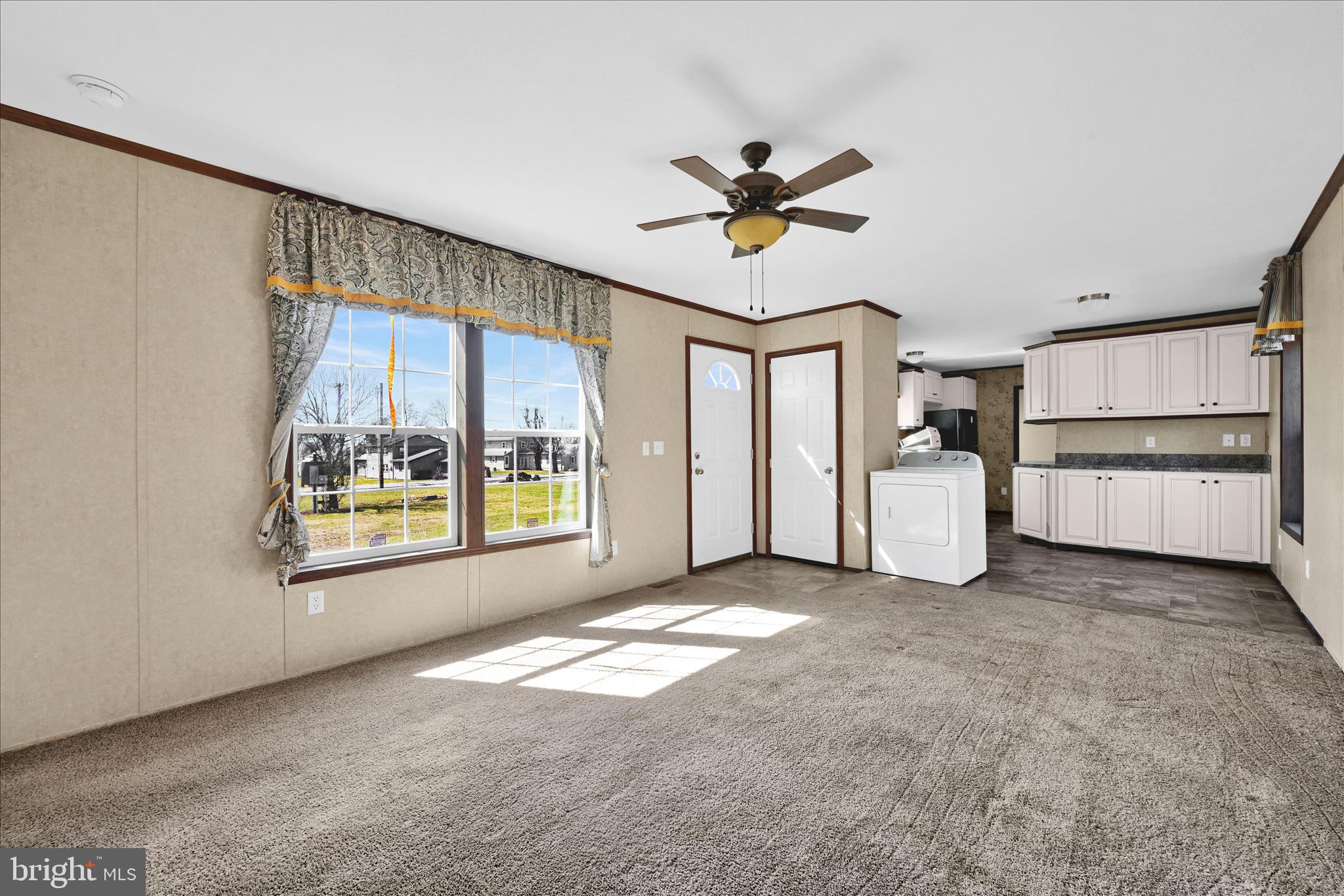 571 Schubert Road Bethel, PA 19507 - Photo 12 of 36 a view of a livingroom with a ceiling fan window and a kitchen view