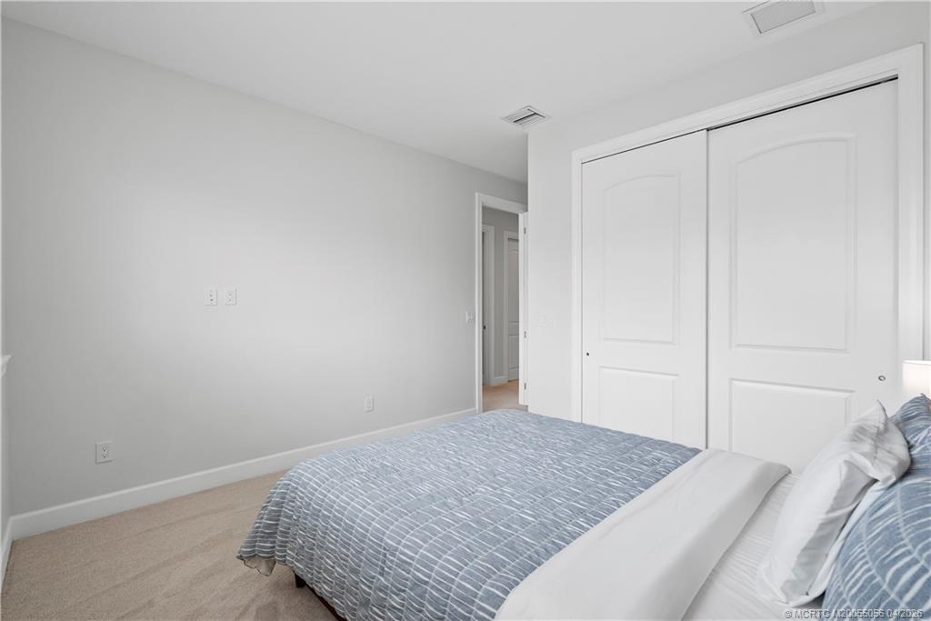 3660 Magnolia Rdg Lane Palm City, FL 34990 - Photo 12 of 35 a bedroom with a bed and a shower