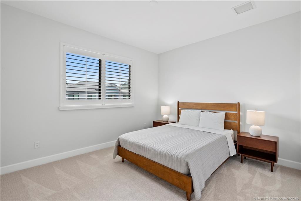 3660 Magnolia Rdg Lane Palm City, FL 34990 - Photo 14 of 35 a bedroom with a bed and a window