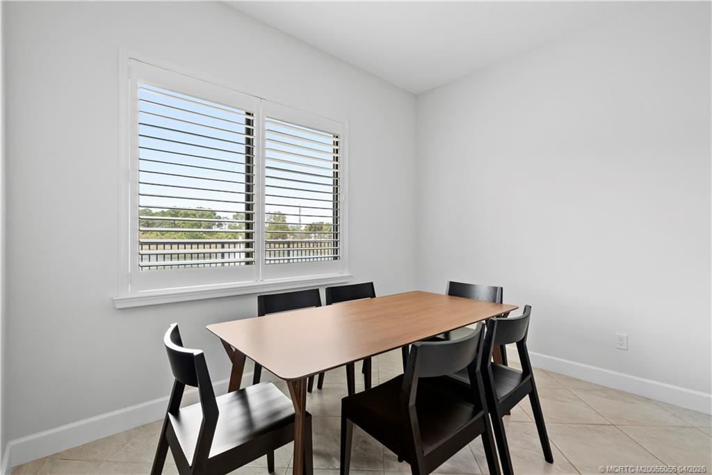 3660 Magnolia Rdg Lane Palm City, FL 34990 - Photo 15 of 35 a view of a dining room with a table and chairs