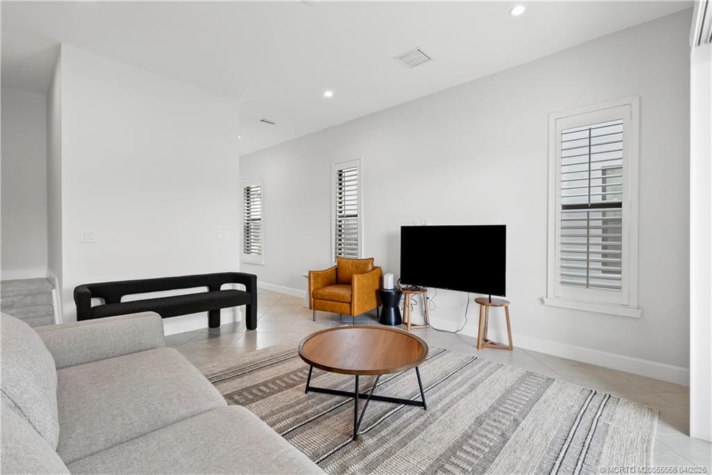 3660 Magnolia Rdg Lane Palm City, FL 34990 - Photo 16 of 35 a living room with furniture a flat screen tv and a rug