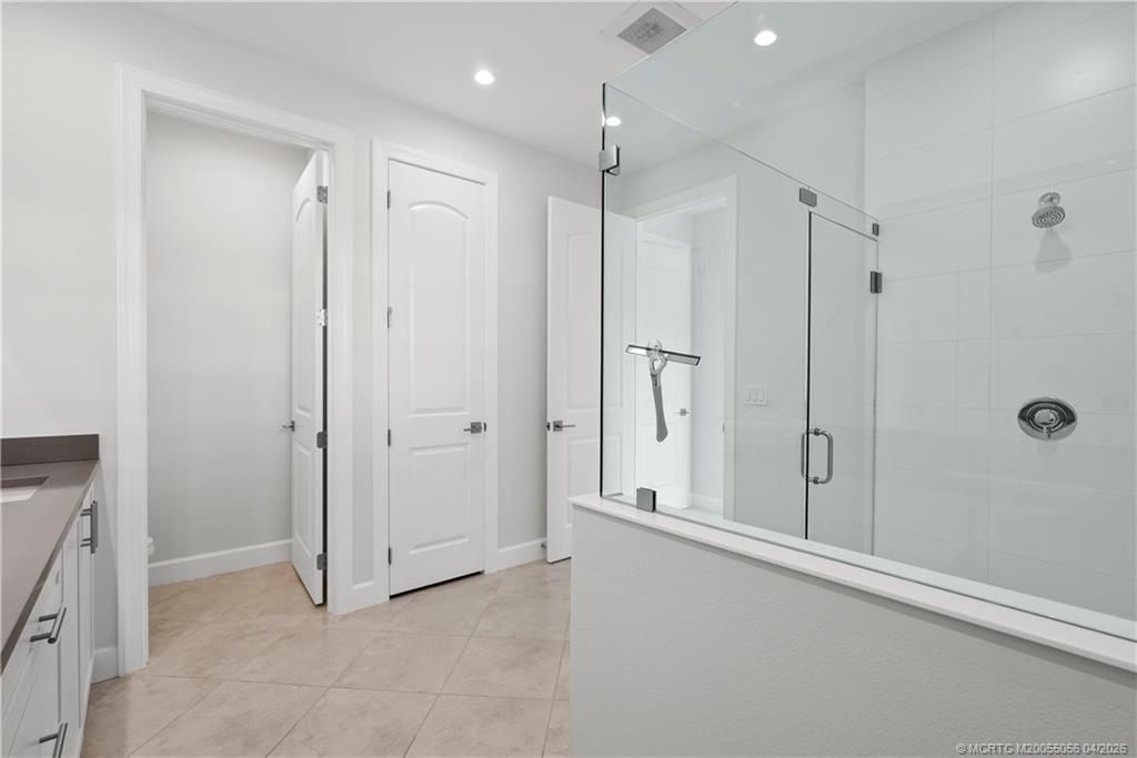 3660 Magnolia Rdg Lane Palm City, FL 34990 - Photo 21 of 35 a view of a bathroom with a shower and a tub