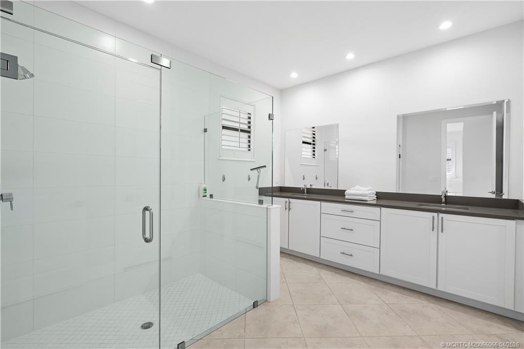 3660 Magnolia Rdg Lane Palm City, FL 34990 - Photo 22 of 35 a spacious bathroom with a shower sink and mirror