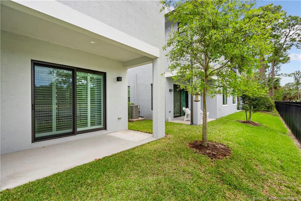 3660 Magnolia Rdg Lane Palm City, FL 34990 - Photo 26 of 35 a view of a house with backyard and garden