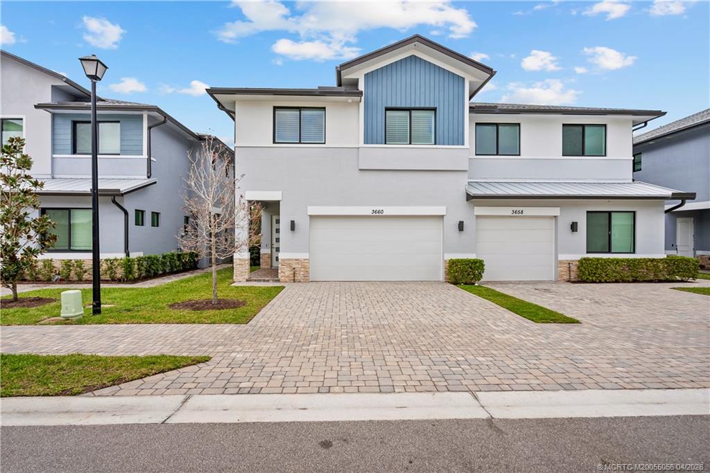 3660 Magnolia Rdg Lane Palm City, FL 34990 - Photo 32 of 35 a front view of a house with a yard and garage
