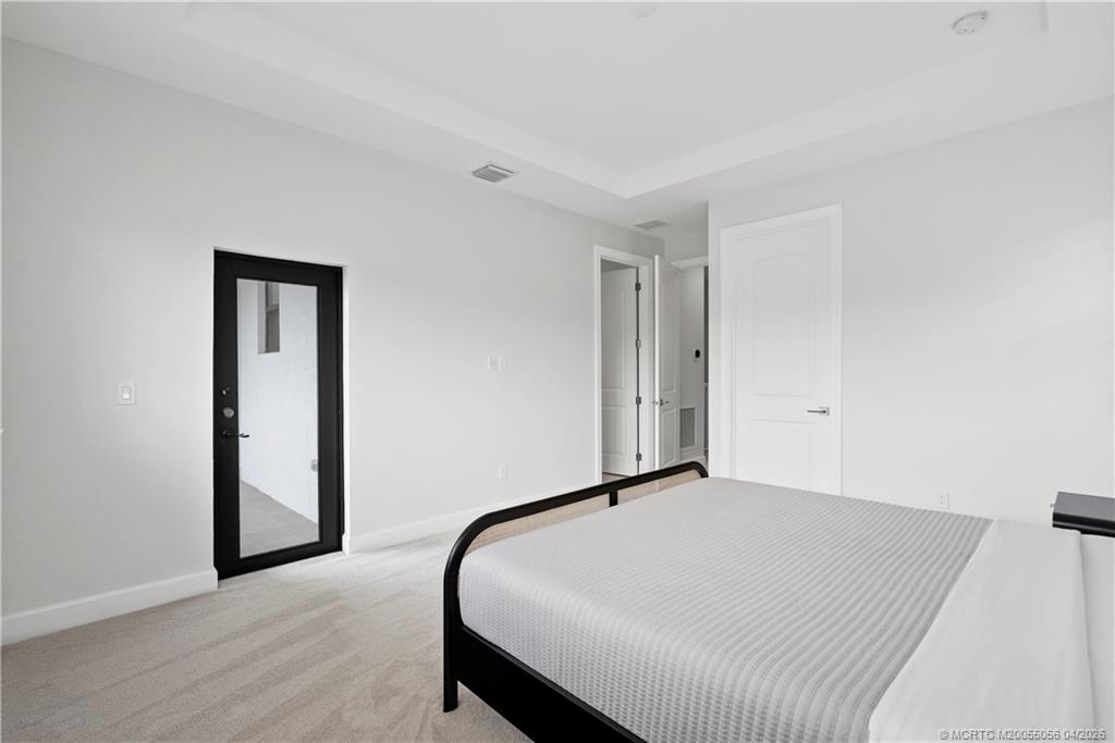 3660 Magnolia Rdg Lane Palm City, FL 34990 - Photo 8 of 35 a bedroom with a bed and wooden floor