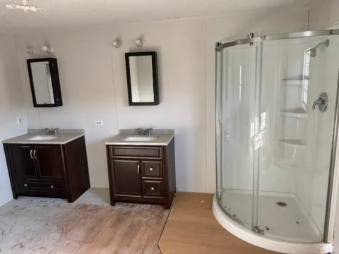 a bathroom with a shower sink and mirror