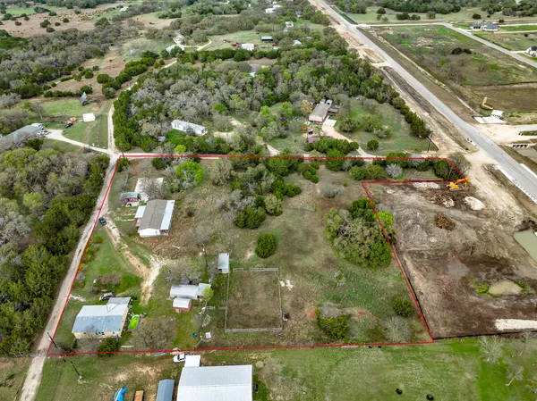 an aerial view of residential houses with outdoor space