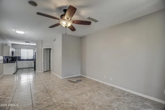 a view of a kitchen with a sink and a refrigerator