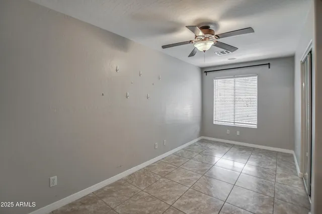 a view of a livingroom with a ceiling fan and window