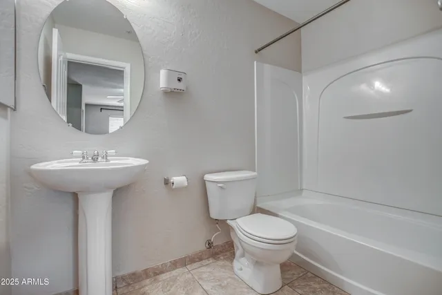 a bathroom with a sink toilet and a mirror