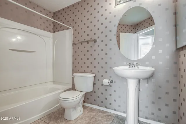 a bathroom with a sink toilet and a mirror