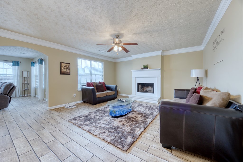 43 Ottawa Trail Fort Mitchell, AL 36856 - Photo 12 of 57 a living room with furniture a fireplace and a chandelier