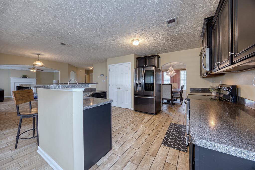 43 Ottawa Trail Fort Mitchell, AL 36856 - Photo 21 of 57 a kitchen with refrigerator and chairs