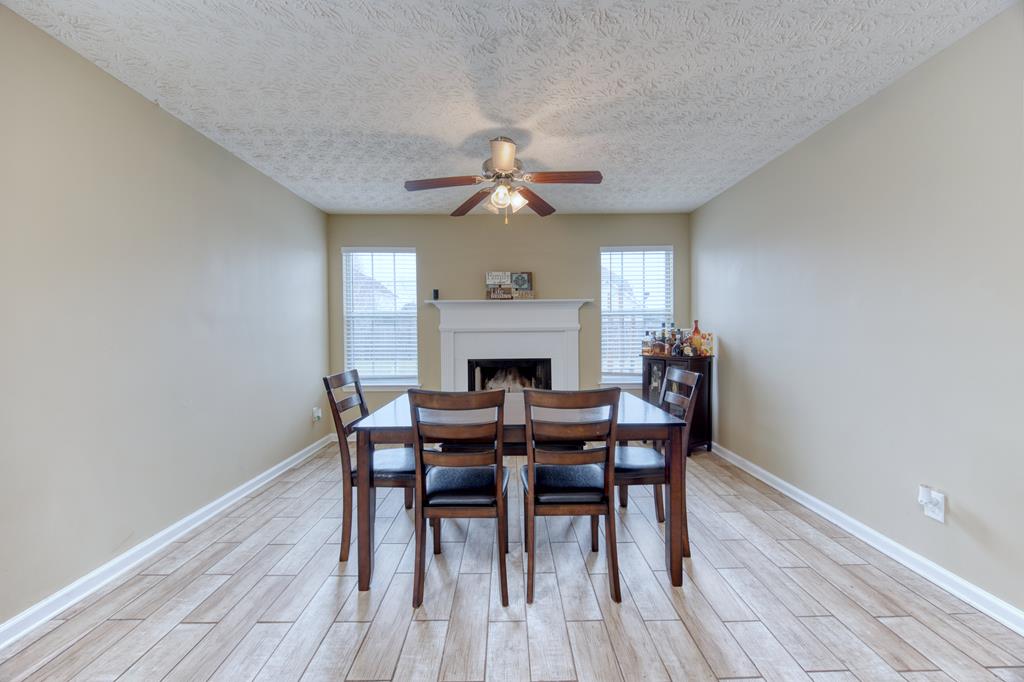 43 Ottawa Trail Fort Mitchell, AL 36856 - Photo 22 of 57 a dining room with furniture a fireplace and wooden floor