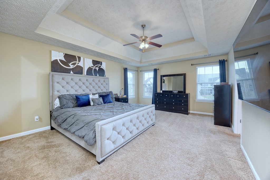 43 Ottawa Trail Fort Mitchell, AL 36856 - Photo 31 of 57 a spacious bedroom with a bed and a chandelier