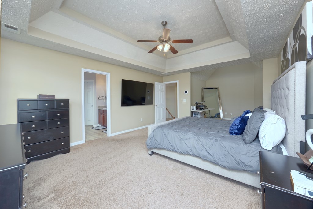 43 Ottawa Trail Fort Mitchell, AL 36856 - Photo 33 of 57 a bedroom with a large bed and a flat tv screen on dresser