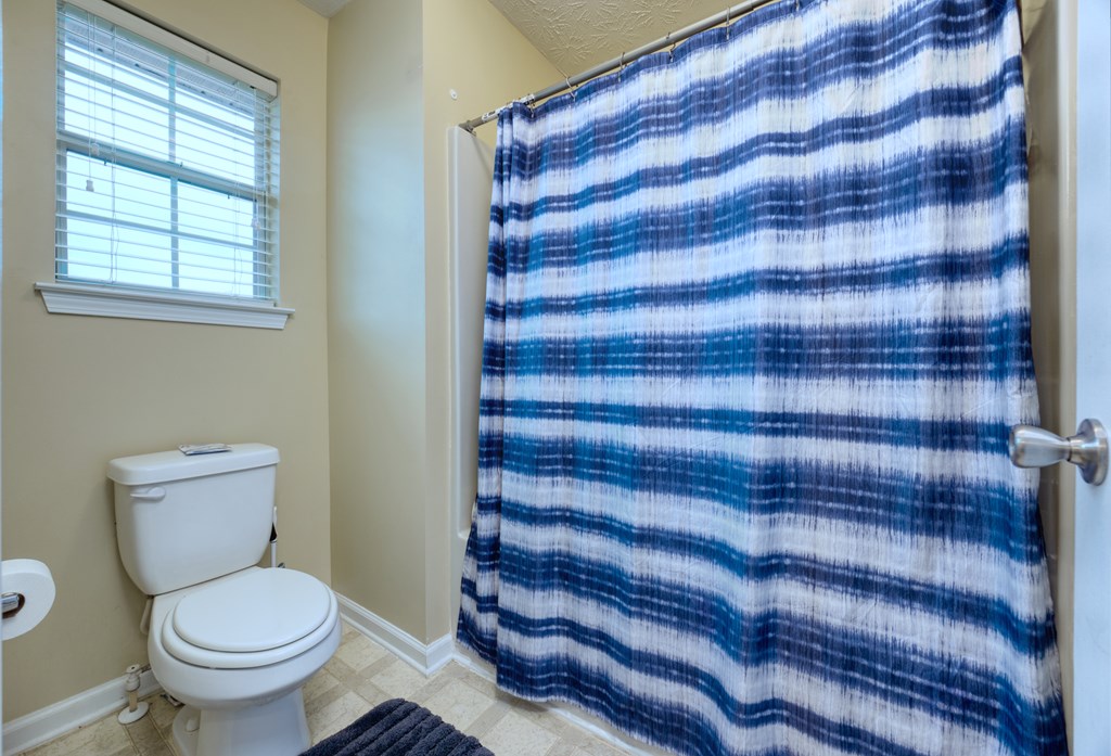 43 Ottawa Trail Fort Mitchell, AL 36856 - Photo 45 of 57 a bathroom with a toilet and a shower curtain