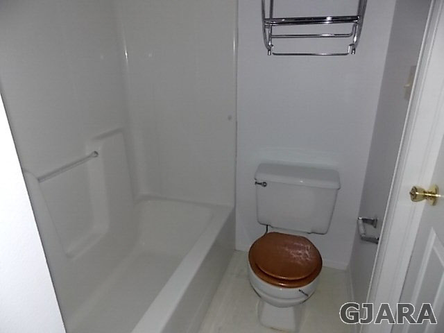 406 Ridges Boulevard, Unit 30 Grand Junction, CO 81507 - Photo 5 of 11 a bathroom with a toilet and a shower