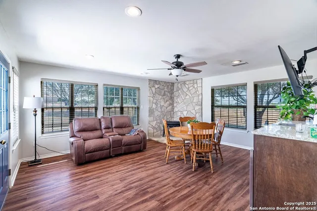 a living room with furniture and a wooden floor