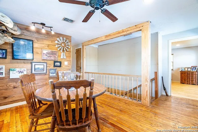a dining room with furniture wooden floor and a chandelier