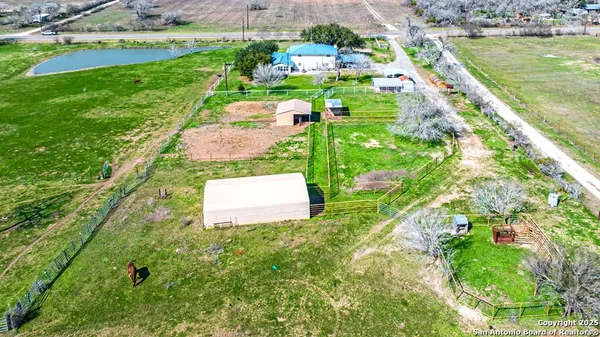 a view of a patio with chairs and potted plants