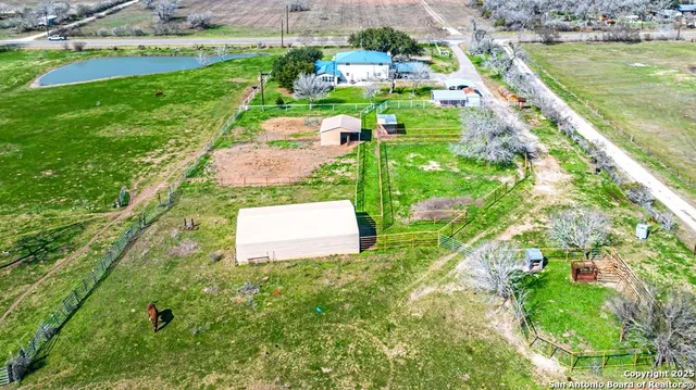 a view of a patio with chairs and potted plants
