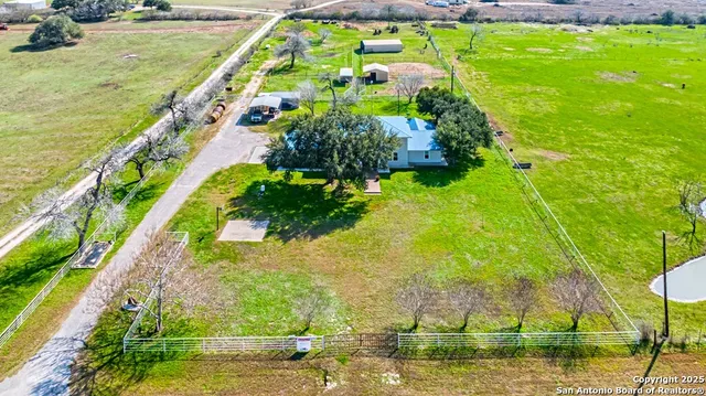 a view of yard with swimming pool and green space