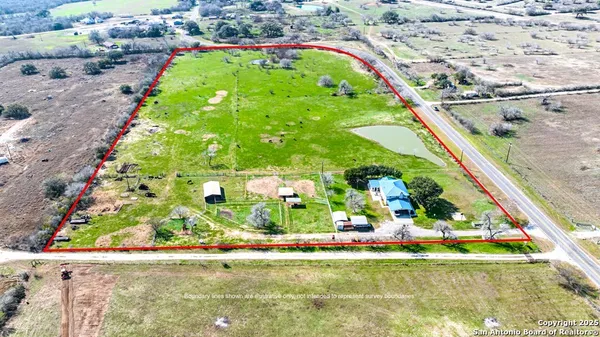 a backyard of a house with lots of green space and fountain