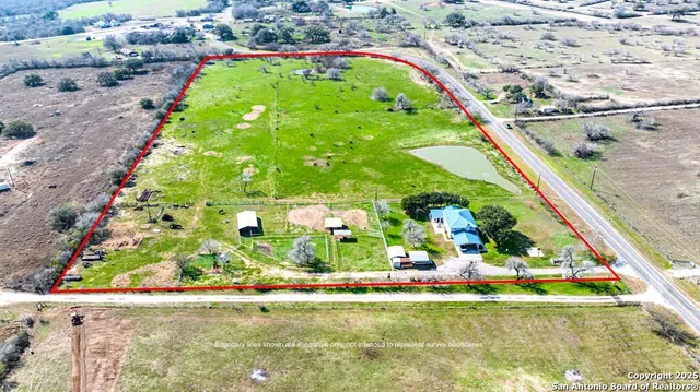 a backyard of a house with lots of green space and fountain