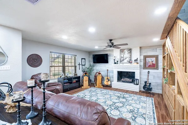 a living room with furniture flat screen tv and a fireplace